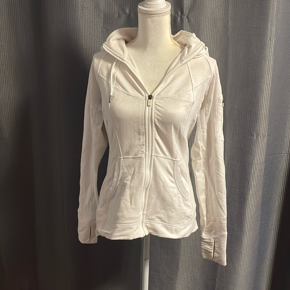 Athletes white zip up jacket with hood.
